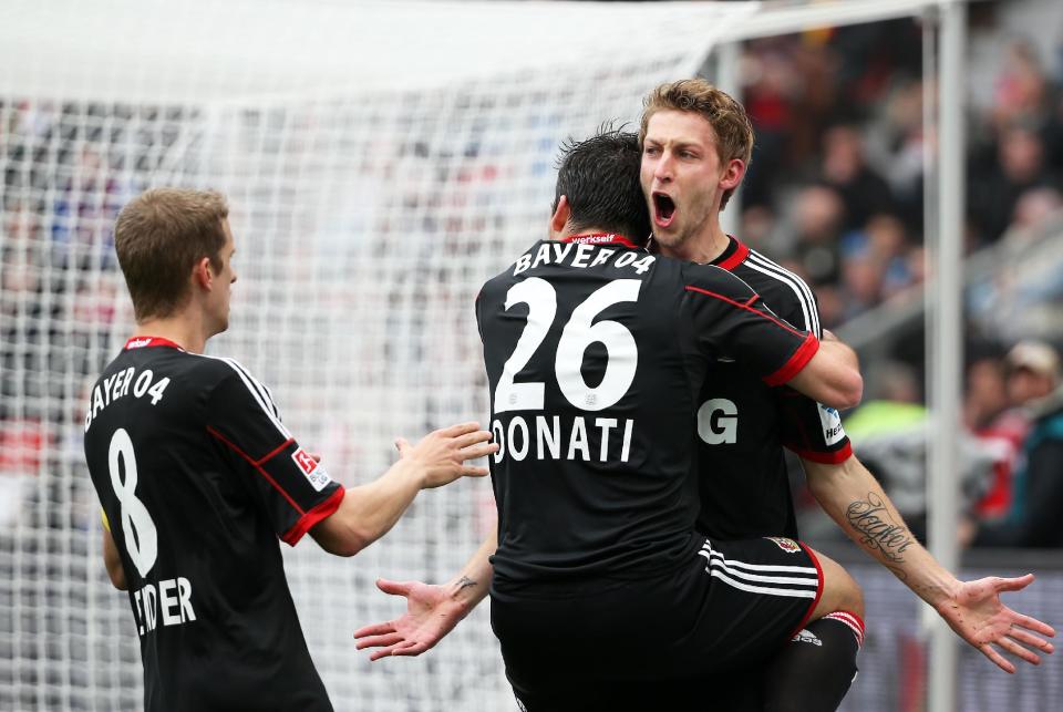 Leverkusen's Stefan Kiessling, right, celebrates with Giulio Donati and Lars Bender, left, after scoring during the German first division Bundesliga soccer match between Bayer Leverkusen and Hertha BSC Berlin in Leverkusen, Germany, Sunday April 13,2014. (AP Photo/Rolf Vennenbernd/dpa)