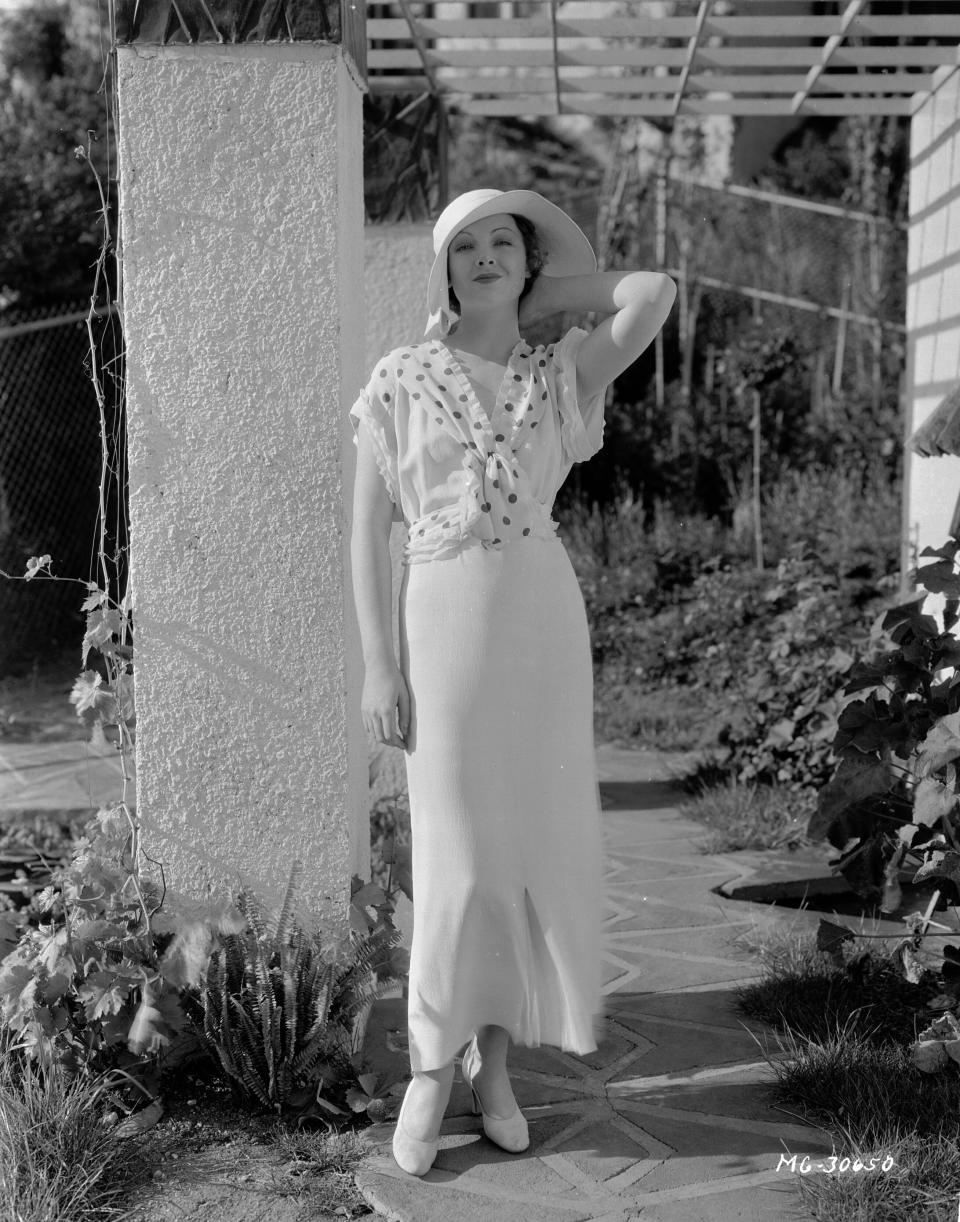 Loy poses in a garden, circa 1933.