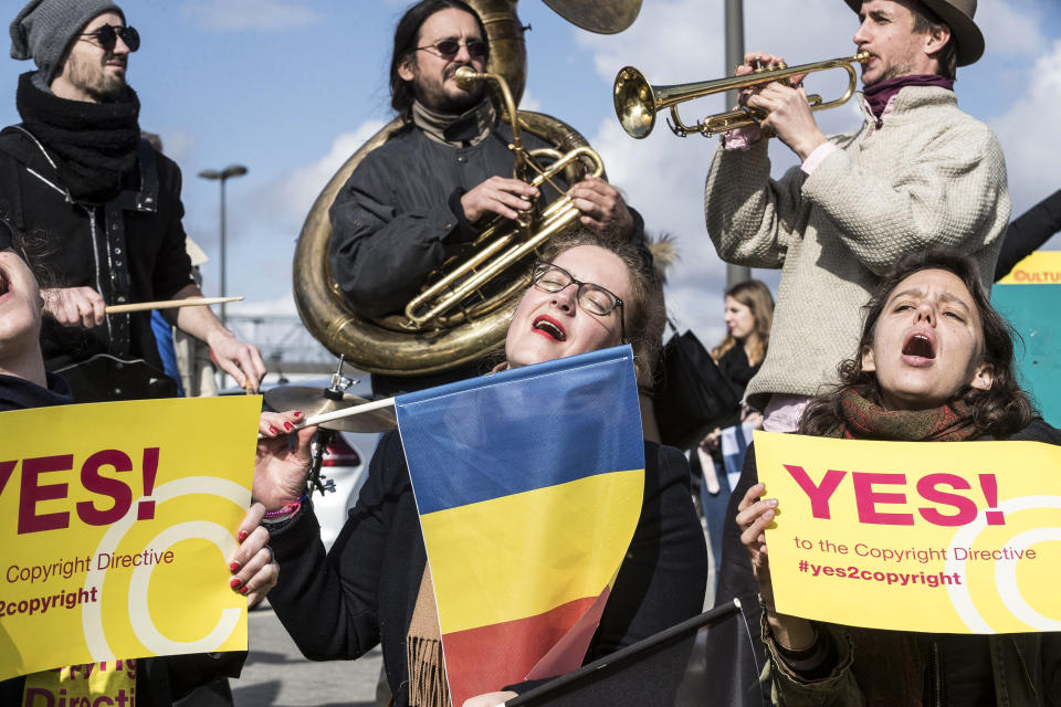 People gather at the front of the European Parliament building in Strasbourg, France, Tuesday March 26, 2019, to show their support for the copyright bill. The European Parliament is furiously debating the pros and cons of a landmark copyright bill one last time before the legislature will vote on it later. (AP Photo/Jean-Francois Badias)