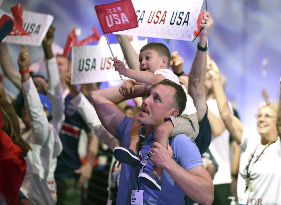 Family and friends of Olympic athletes watch the televised Olympics action live at the Olympic Family & Friends Experience at the Loews Sapphire Falls Resort at Universal Orlando in Orlando, Fla., Friday, July 30, 2021. Parents, siblings, friends and former teammates crowd into the ballroom at the resort daily to watch the Summer Games and bond with others in a similar situation, all of them unable to be in Tokyo to root on their loved ones competing for gold because of the coronavirus pandemic. (Stephen M. Dowell/Orlando Sentinel via AP)