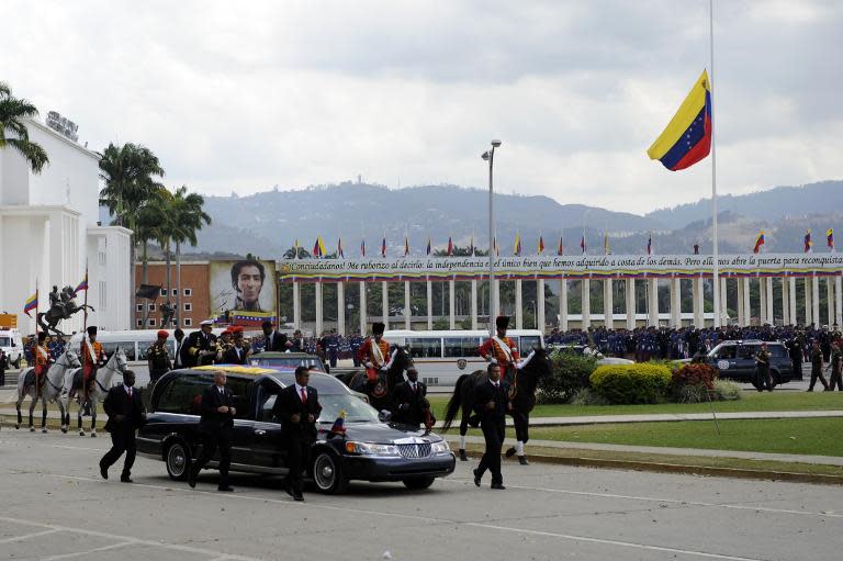 The hearse with the remains of late Venezuelan President Hugo Chavez is taken from the Military Academy to his resting place at the former "4 de Febrero" barracks in Caracas, on March 15, 2013