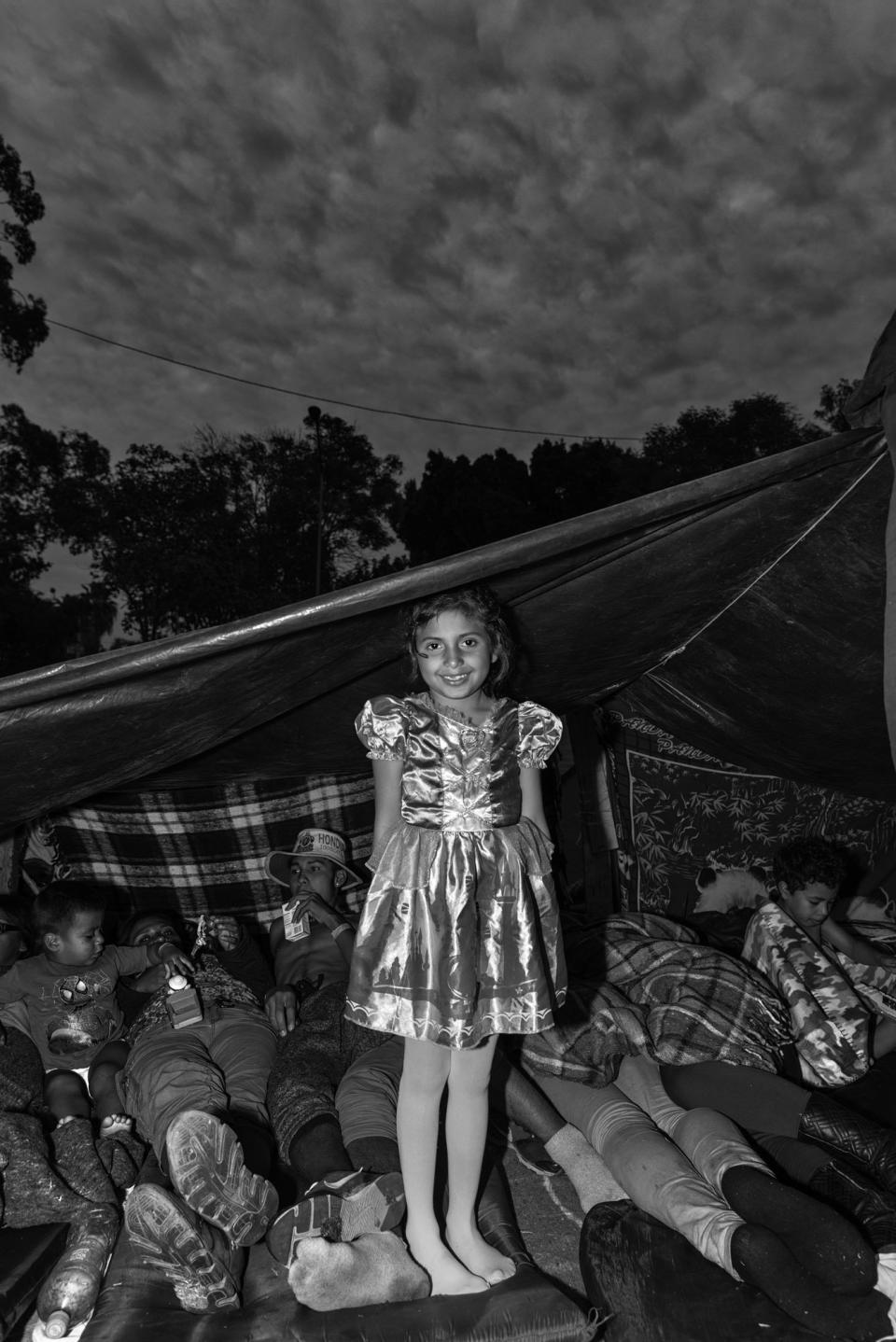 <i>The Princess, Benito Juarez Shelter</i><br />Ana rests against her tent inside Benito Juaez, a massive shelter in Tijuana, Mexico. Ana and her parents traveled from Honduras hoping to cross into the United States, but amidst the chaos at the border, they sought refuge at the shelter. (Photo: Ada Trillo)