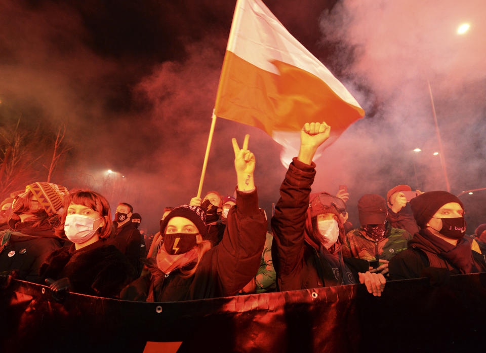 People protest against new anti-abortion laws, near the ruling Law and Justice party headquarters in Warsaw, Poland Wednesday Jan. 27, 2021, to protest after the country's top court on Wednesday confirmed its highly divisive ruling that will further tighten the predominantly Catholic nation's strict anti-abortion law. The Constitutional Tribunal published the justification of its decision, which will take immediate effect.(AP Photo/Czarek Sokolowski)