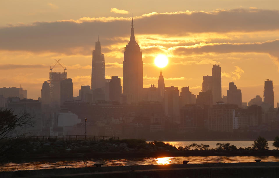 The sun rises behind the skyline of midtown Manhattan, the Chrysler Building and the Empire State Building in New York City shrouded with smoke from wildfires in Canada on June 29, 2023, as seen from Jersey City, New Jersey. / Credit: Gary Hershorn / Getty Images