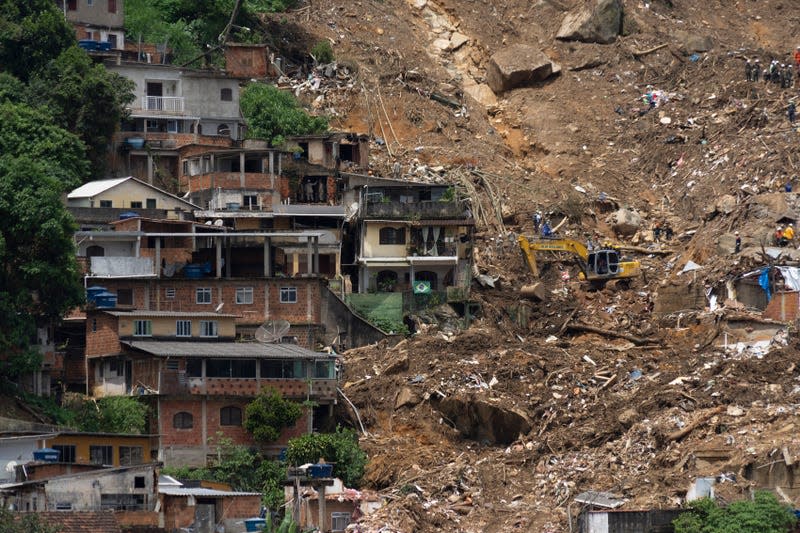 Alex Sandro Conde’s house stands next to the devastation caused by a landslide at Morro da Oficina, a hillside part of Alto da Serra, Petropolis, Rio de Janeiro state, Brazil, Tuesday, Feb. 22, 2022.