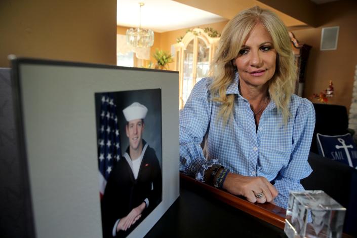 Regina Mullen looks over to a photo of her son Kyle in her Manalapan home Friday, April 22, 2022. The investigation is still ongoing into how Kyle died during Navy SEAL training in February.
