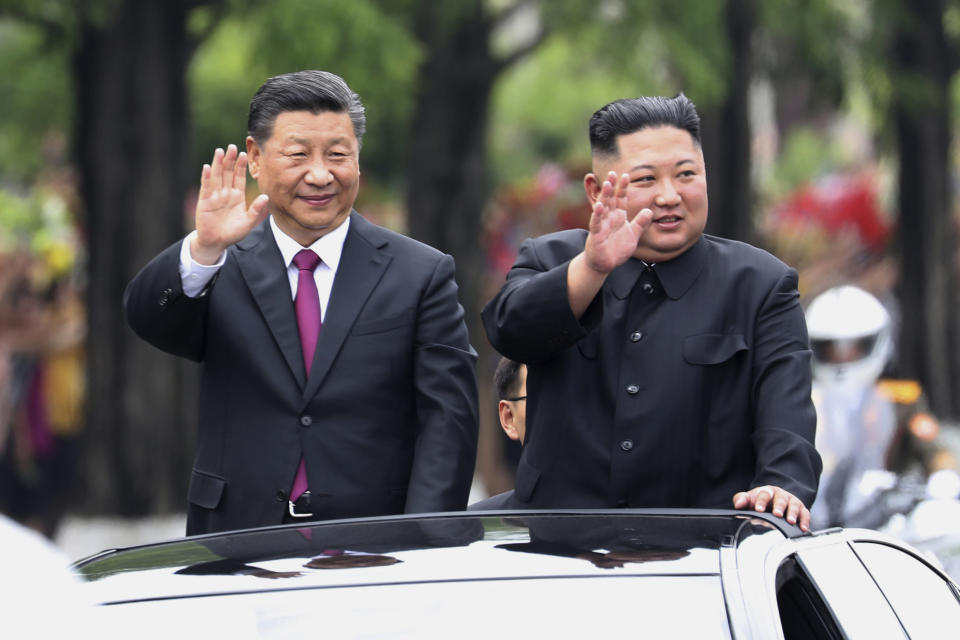 FILE - In this June 20, 2019, file photo released by China's Xinhua News Agency, visiting Chinese President Xi Jinping, left, and North Korean leader Kim Jong Un wave from an open top limousine as they travel along a street in Pyongyang, North Korea. Since taking power after his father’s death in 2011, Kim has spent 10 years erasing doubts that he was too young and weak to extend his family’s brutal dynastic grip over the impoverished, nuclear-armed state. (Ju Peng/Xinhua via AP, File)