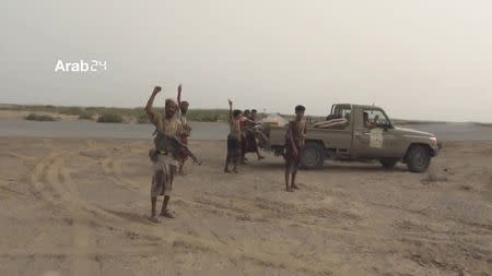 Armed members of Arab-backed Yemeni forces are seen near the airport on the outskirts of Hodeidah, Yemen, June 20, 2018 in this still image taken from video. ARAB 24 via REUTERS