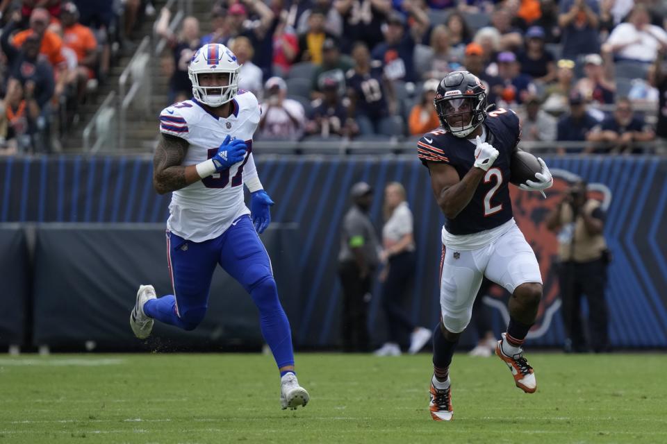 Chicago Bears' DJ Moore (2) runs past Buffalo Bills' Darrynton Evans during the first half of an NFL preseason football game, Saturday, Aug. 26, 2023, in Chicago. (AP Photo/Nam Y. Huh)