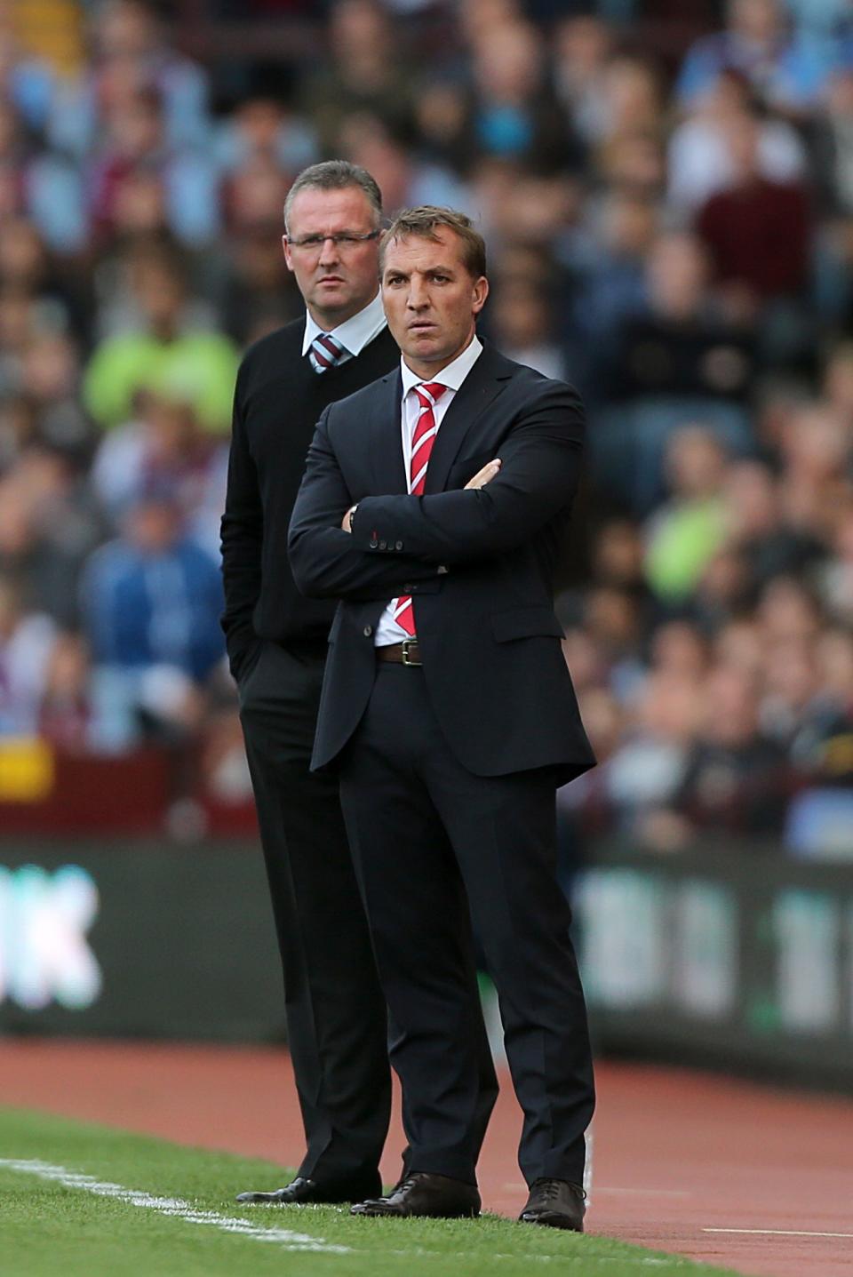 Aston Villa manager Paul Lambert (back) on the touchline alongside Liverpool manager Brendan Rodgers