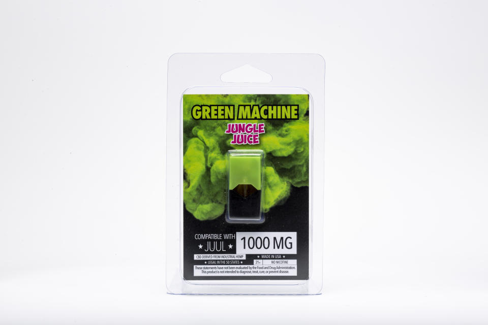 This Wednesday, July 17, 2019, photo shows a Green Machine "Jungle Juice" flavored CBD vape pod and its packaging in Los Angeles. As part of an investigation into vapes that promise to deliver a smokable form of the cannabis extract CBD, The Associated Press commissioned a laboratory to test CBD vapes purchased around the country. That included seven Green Machine pods bought at stores in California, Florida and Maryland; four of the pods contained synthetic marijuana, a dangerous street drug commonly known as K2 or spice. (AP Photo/Damian Dovarganes)
