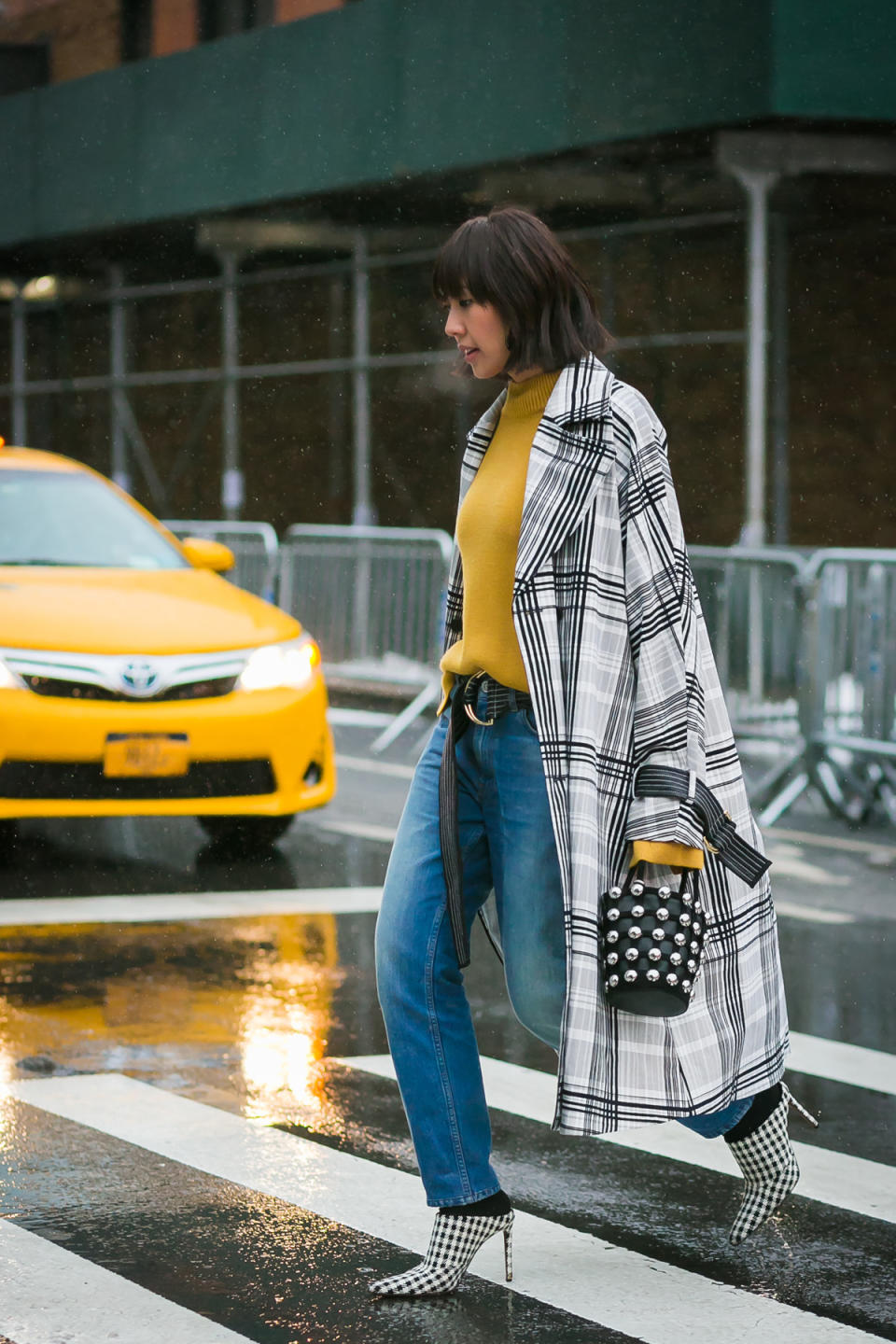 Liz Uy wears the coolest oversized coat and studded bag at New York Fashion Week.