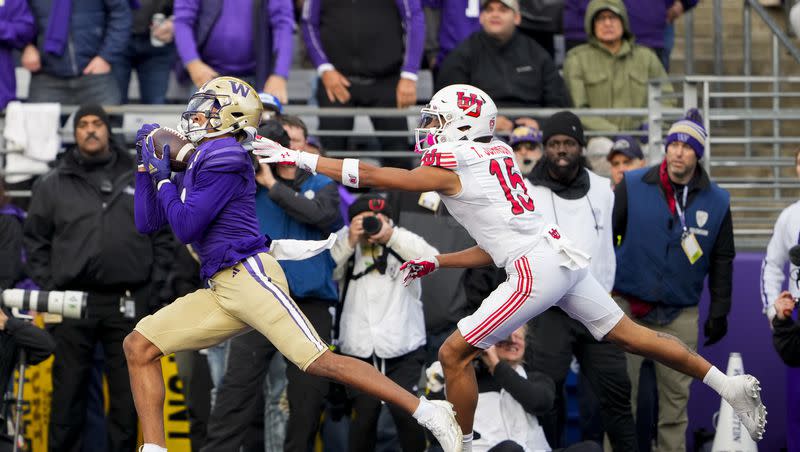 Washington wide receiver Rome Odunze, left, makes a touchdown catch in front of Utah cornerback Tao Johnson (15) during the first half of an NCAA college football game Saturday, Nov. 11, 2023, in Seattle.