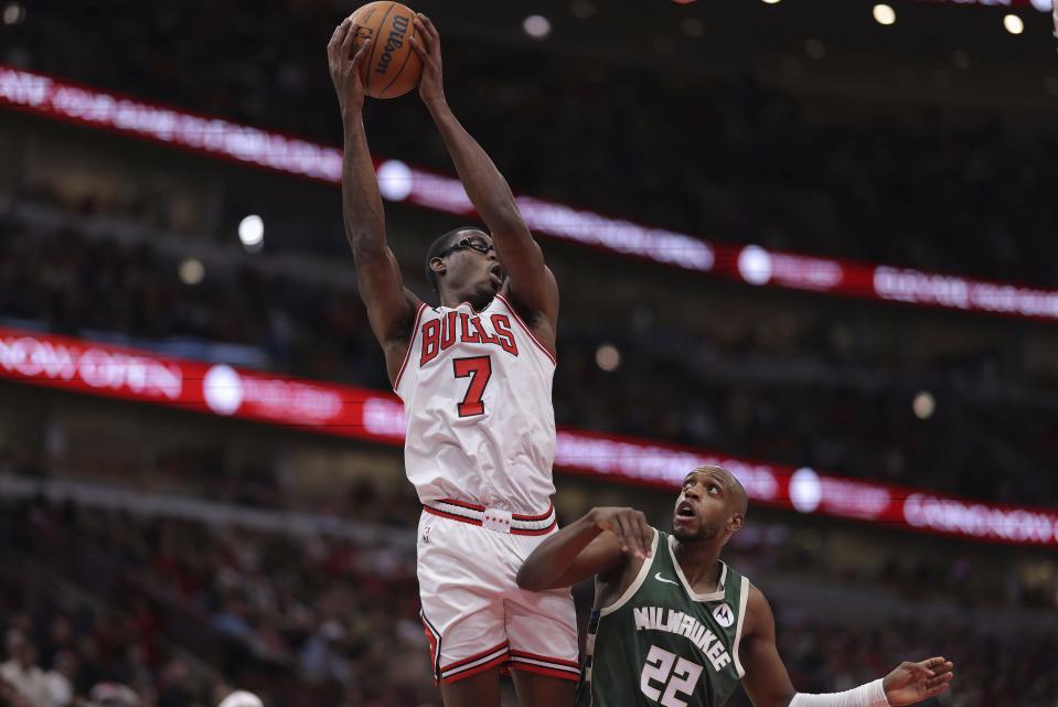 Chicago Bulls forward Jalen Smith (7) grabs a rebound over Milwaukee Bucks forward Khris Middleton (22) during the first half of an NBA basketball game Monday, Dec. 23, 2024, in Chicago. (AP Photo/Melissa Tamez)