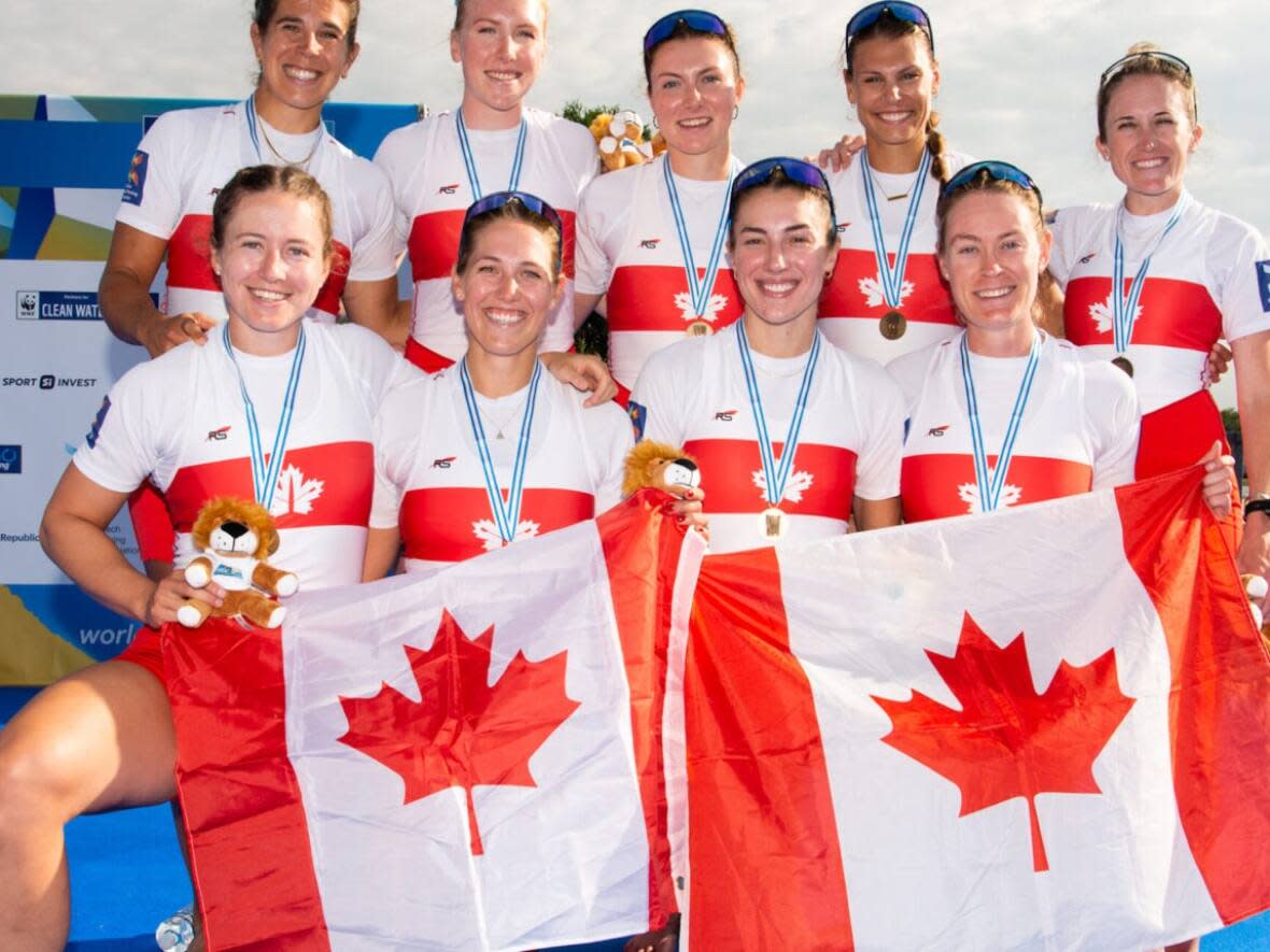 Canada's women's eight rowing squad pose with its bronze medal at the world championships in Racice, Czech Republic, on Sunday. (Rowing Canada - image credit)