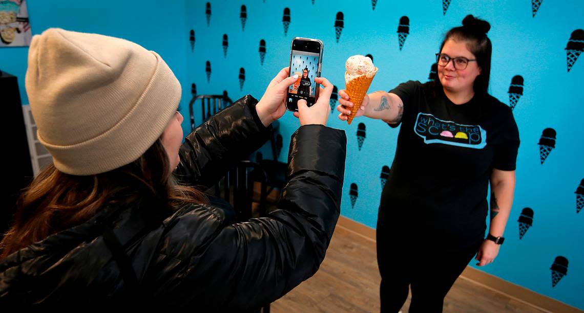 Mallory Chapin, owner of What’s the Scoop?, poses for a photo likely to end up in a social media post about the new Kennewick ice cream store. Chapin’s cousin, Courtney Brady, is taking the photo.