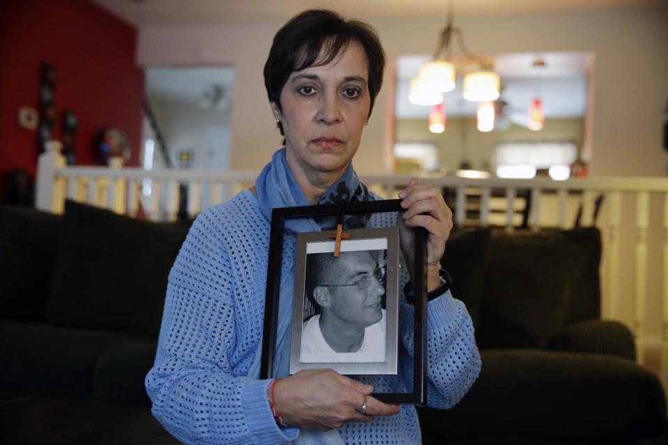 In this Monday, March 17, 2014 photo, Patty DiRenzo holds a picture of her son, Salvatore Marchese, in her home in Blackwood, N.J. Salvatore died from a heroin overdose in 2010. DiRenzo spent years trying to get help for him, but was denied for many reasons - she was constantly told she didn’t meet the "criteria" for treatment centers, she even got turned away from emergency rooms because doctors say alcohol withdrawal is life threatening, but heroin withdrawal is not. (AP Photo/Mel Evans)