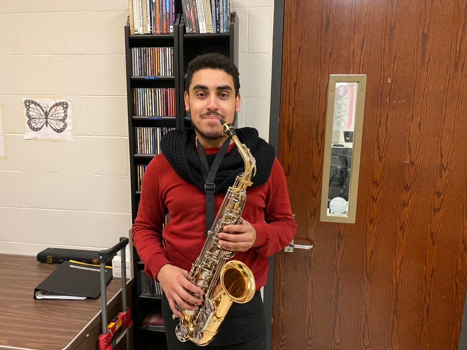 Taunton High School senior Caio Dos Santos-Amado with his saxophone on Wednesday Feb. 1, 2023 at the high school.