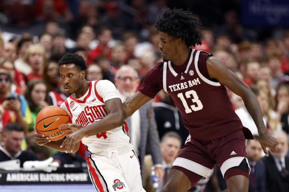 Texas A&M forward Solomon Washington, right, forces a turnover against Ohio State guard Dale Bonner, left, during the first half of an NCAA college basketball game in Columbus, Ohio, Friday, Nov. 10, 2023. (AP Photo/Paul Vernon)