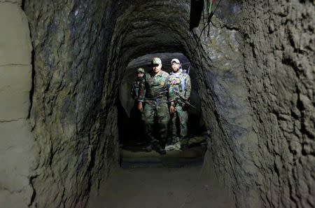 Afghan Special Forces inspect inside a cave which was used by suspected Islamic State militants at the site where a MOAB, or ''mother of all bombs'', struck the Achin district of the eastern province of Nangarhar, Afghanistan. REUTERS/Parwiz