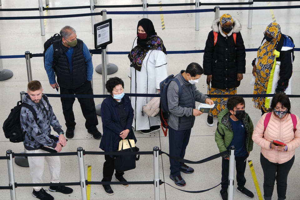 People stand in a security line at John F.  Kennedy Airport in New York City in 2022. 