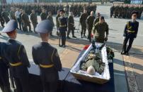 Ukrainian servicemen pay their respects to a member of the National Guard killed in clashes in Kiev during his funeral on September 2, 2015