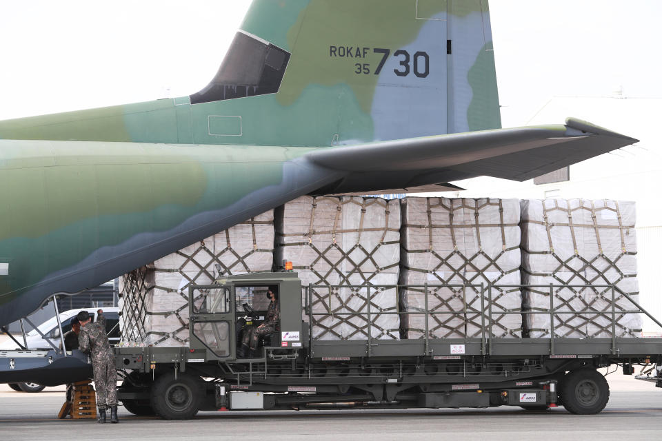 Boxes containing masks are loaded onto a South Korea Air Force cargo plane at the Gimhae airbase in Busan, South Korea, Friday, May 8, 2020. Military aircraft will be used to transport 500,000 masks intended for U.S. veterans of the 1950-53 Korean War as South Korea expands efforts to help other countries deal with the coronavirus while its own outbreak slows. (Son Hyung-joo/Yonhap via AP)