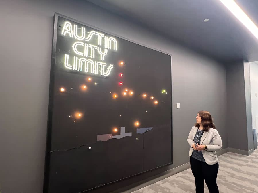 Liz Antaramian, Director of Archives at Austin PBS, in front of a backdrop from Austin City Limits TV show’s set (KXAN Photo/Abigail Jones)