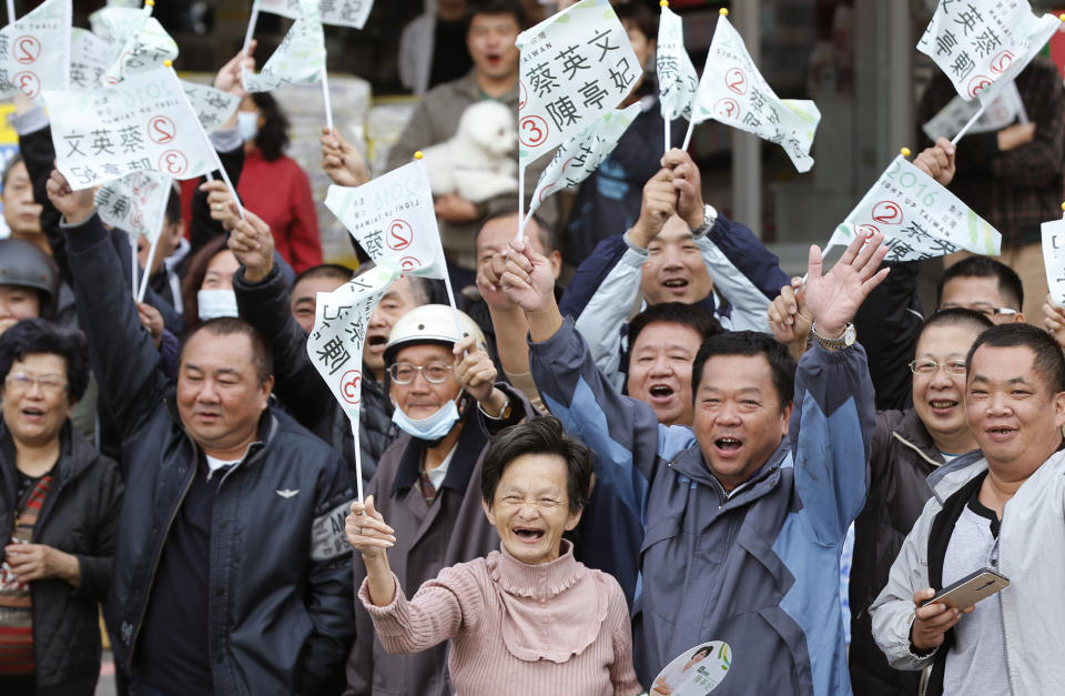 FILE - In this Jan. 10, 2016, file photo, supporters cheer as Taiwan's Democratic Progressive Party then-presidential candidate Tsai Ing-wen parades through a street in Tainan, Taiwan. The residents of this self-governing island are supporting their president Tsai as she stands up to China’s calls for unification with the mainland. (AP Photo/Wally Santana, File)