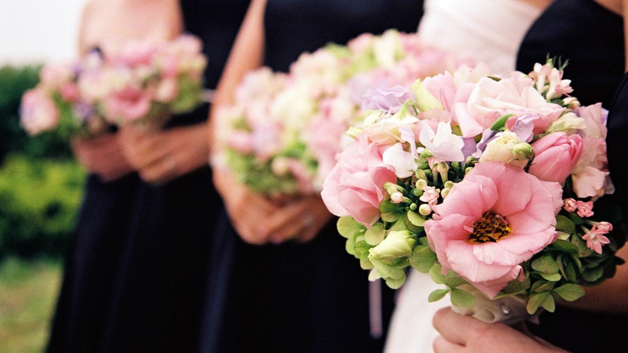 Bridesmaids with flowers - foreground only in focus.