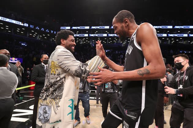 Kyrie Irving, just a spectator on Sunday, greets Brooklyn Nets teammate Kevin Durant after he scored 53 points against the Knicks in a victory. (Photo: Nathaniel S. Butler via Getty Images)