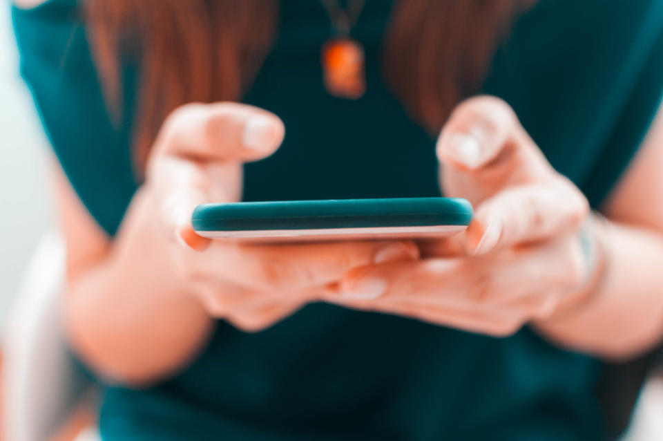 A close-up view of a young woman using her smartphone