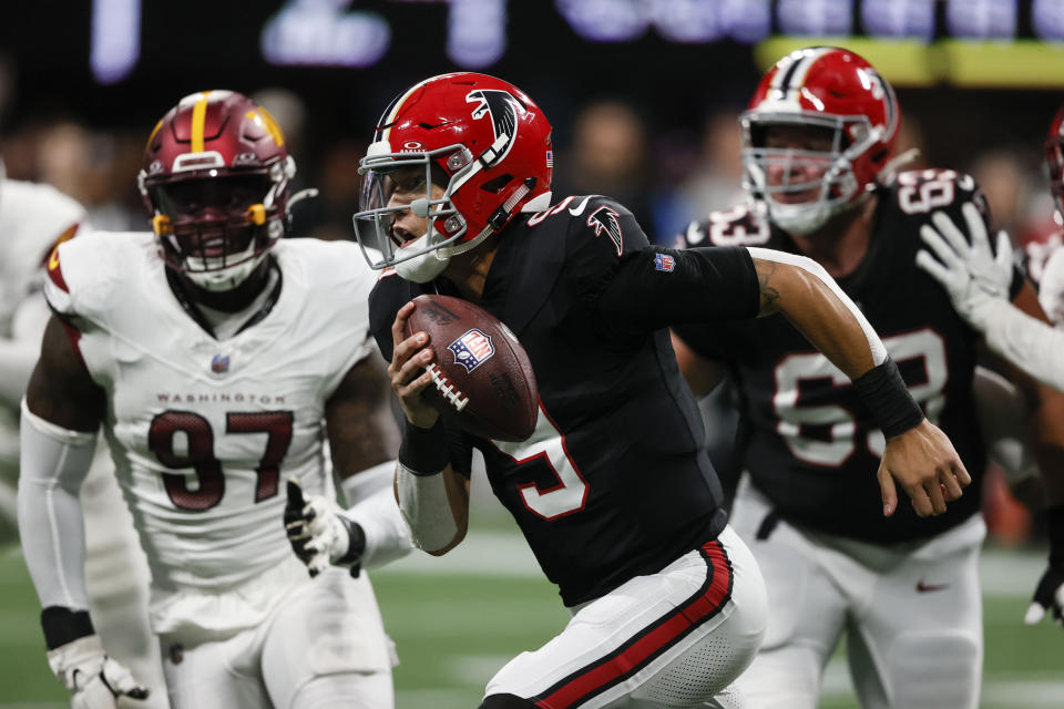 Atlanta Falcons quarterback Desmond Ridder (9) scrambles for a first down against the Washington Commanders during the second half of an NFL football game, Sunday, Oct. 15, 2023, in Atlanta. (AP Photo/Butch Dill)