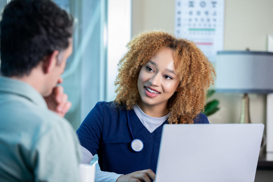 a nurse talking to a patient