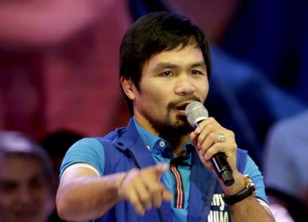 Filipino boxer Manny Pacquiao, who is running for Senator in the May 2016 vice-presidential election, speaks to supporters during the start of national elections campaigning in Mandaluyong city, Metro Manila February 9, 2016. REUTERS/Janis Alano