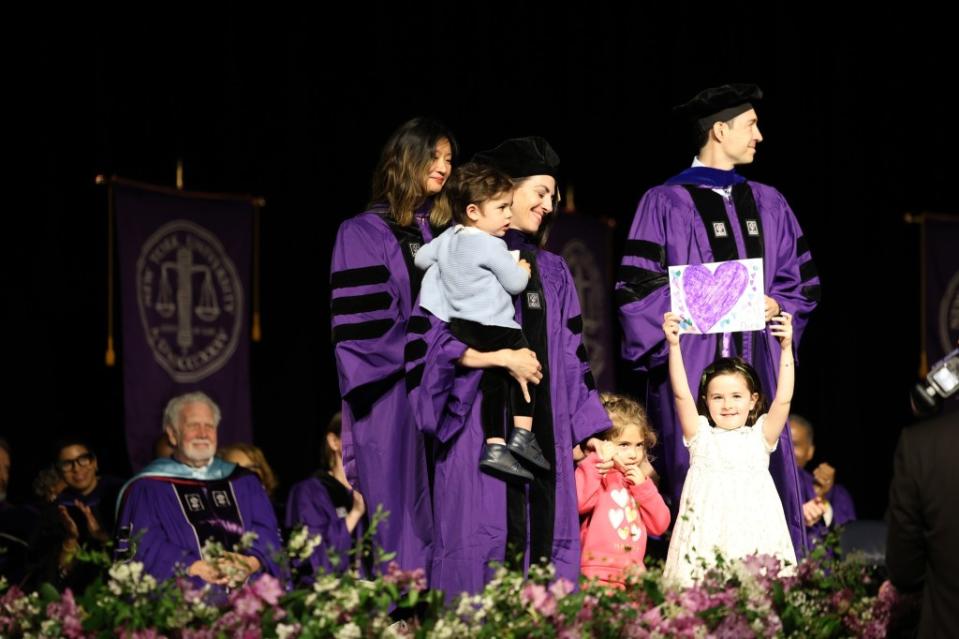 Eden Rose Neiger walked on stage with her graduating mom and held up a picture of a heart she had drawn during the ceremony. FaceBook NYU School of Law