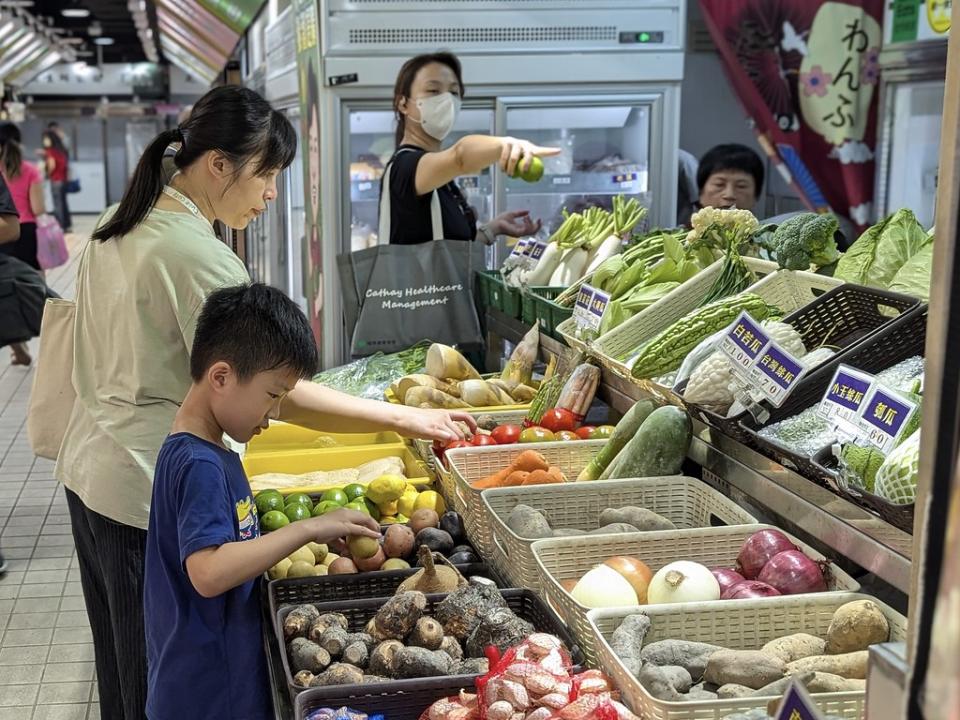 民眾在菜市場選購蔬菜。攝影：陳昭宏