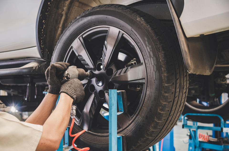 The car mechanic is changing the tire.