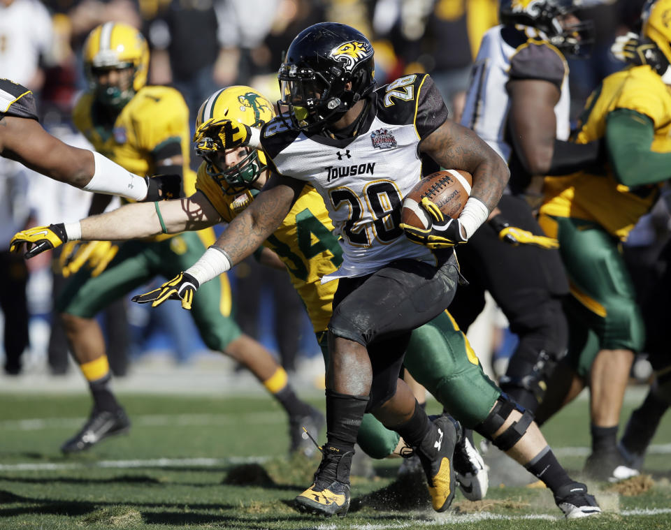 Towson running back Terrance West (28) looks for a gap at the line of scrimmage on a running play in the first half of the FCS championship NCAA college football game against North Dakota State, Saturday, Jan. 4, 2014, in Frisco, Texas. (AP Photo/Tony Gutierrez)