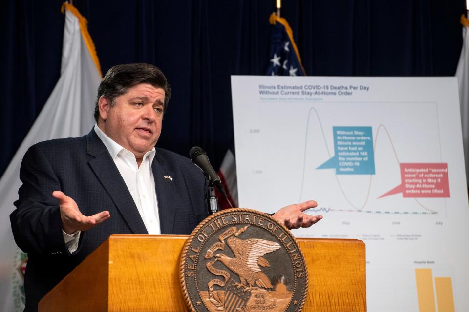 In this April 23, 2020 file photo, Gov. J.B. Pritzker announces an extension of the stay at home order for Illinois as well as a mandatory face covering order at his daily Illinois coronavirus update at the Thompson Center.