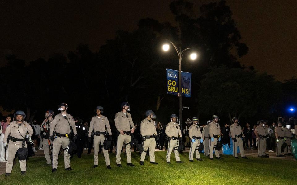 US Police officers stand guard after clashes erupted on the campus of the University of California Los Angeles