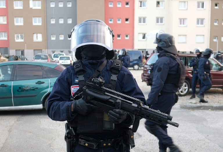 Police secure the area during a search operation at the Ozanam housing estate in Carcassonne following the shooting spree by a jihadist who is believed to have links to the estate