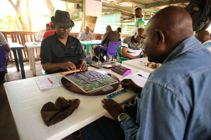 Anthony Ikolo, former President of the Nigeria scrabble federation arranges his tiles during a scrabble competition in Abuja