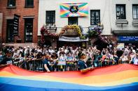 <p>A giant pride flag is displayed by marchers outside the Stonewall Inn during the 49th annual New York City Gay Pride Parade, June 24, 2018. (Photo: Alba Vigaray/EPA-EFE/REX/Shutterstock) </p>