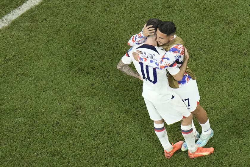 Christian Pulisic of the United States, left, and Cristian Roldan of the United States react at the end of the World Cup round of 16 soccer match between the Netherlands and the United States, at the Khalifa International Stadium in Doha, Qatar, Saturday, Dec. 3, 2022. The Netherlands won 3-1. (AP Photo/Hassan Ammar)