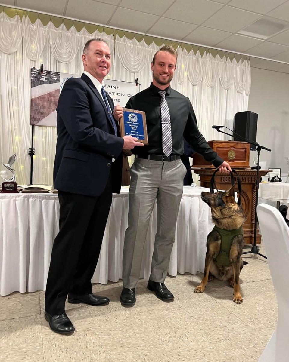 York police Sgt. Jonathan Rogers (right) and his K9 partner Gunter receives an award from the Maine Association of Police Jan. 28.