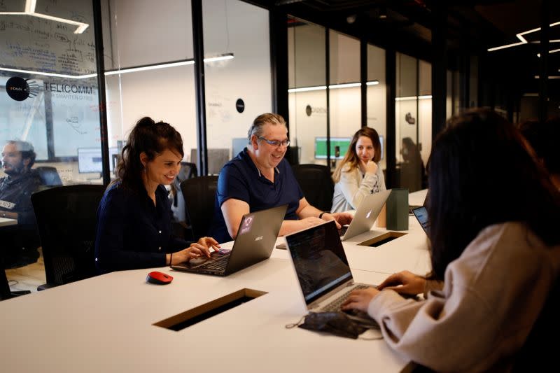 Neta Schreiber, CEO and Co-Founder at SafeUP, a women's safety net application, works with her team members at a co-working space in Tel Aviv