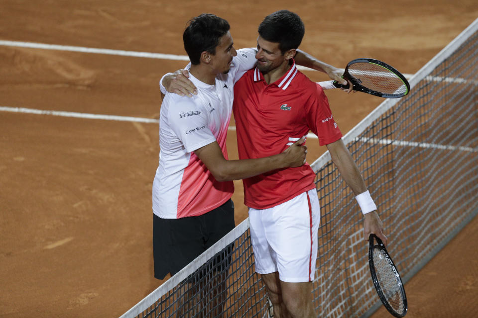 Serbia's Novak Djokovic, right, greets Italy's Lorenzo Sonego after their semi-final match at the Italian Open tennis tournament, in Rome, Saturday, May 15, 2021. Djokovic won 6-3 6-7 6-2. (AP Photo/Gregorio Borgia)
