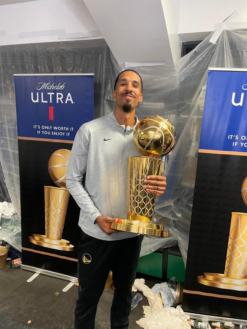 Peoria native Shaun Livingston poses with the Larry O'Brien trophy, given to the NBA world champion. Livingston works in the front office with the 2022 champion Golden State Warriors.