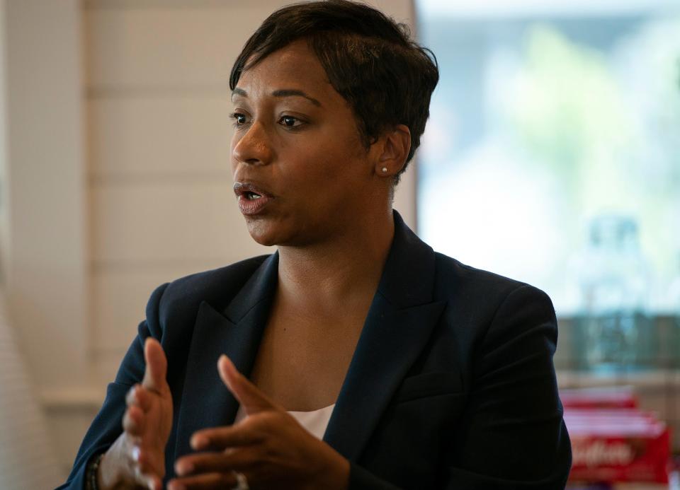 Attorney general candidate Andrea Campbell talks to people gathered at a campaign event at the Franklin St. Cafe on Franklin Street in Framingham, Aug. 12, 2022.